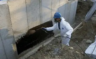 Professional waterproofing the exterior walls of the basement in Detroit, MI